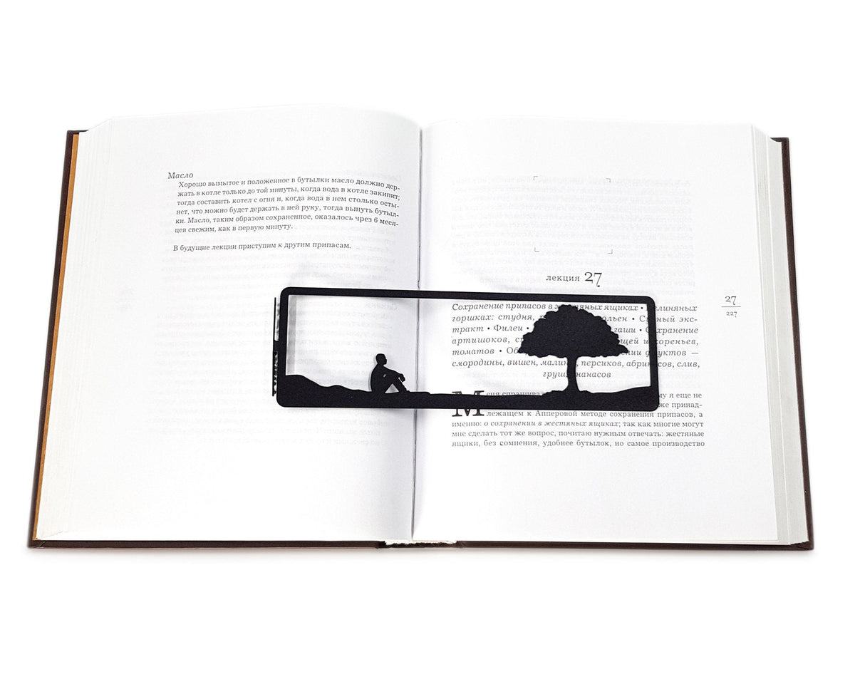 Inspirational Tranquility metal bookmark resting on the pages of an open book