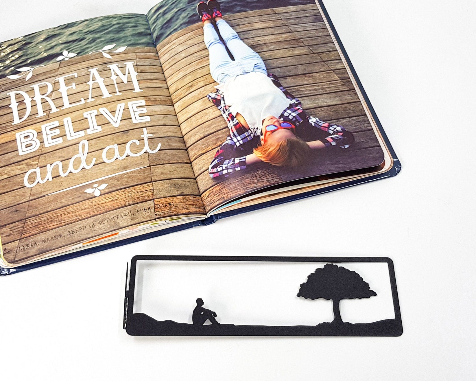 Inspirational Tranquility metal bookmark on an illustrated page