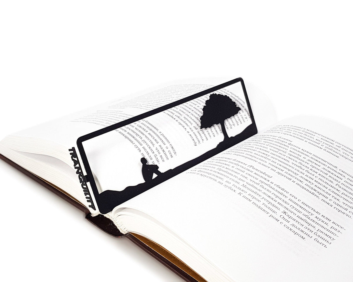 Inspirational Tranquility metal bookmark set into the gutter of an open book