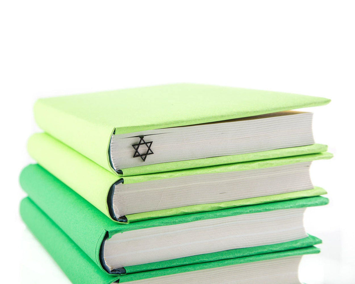Judaical Star of David metal bookmark shown with a stack of books
