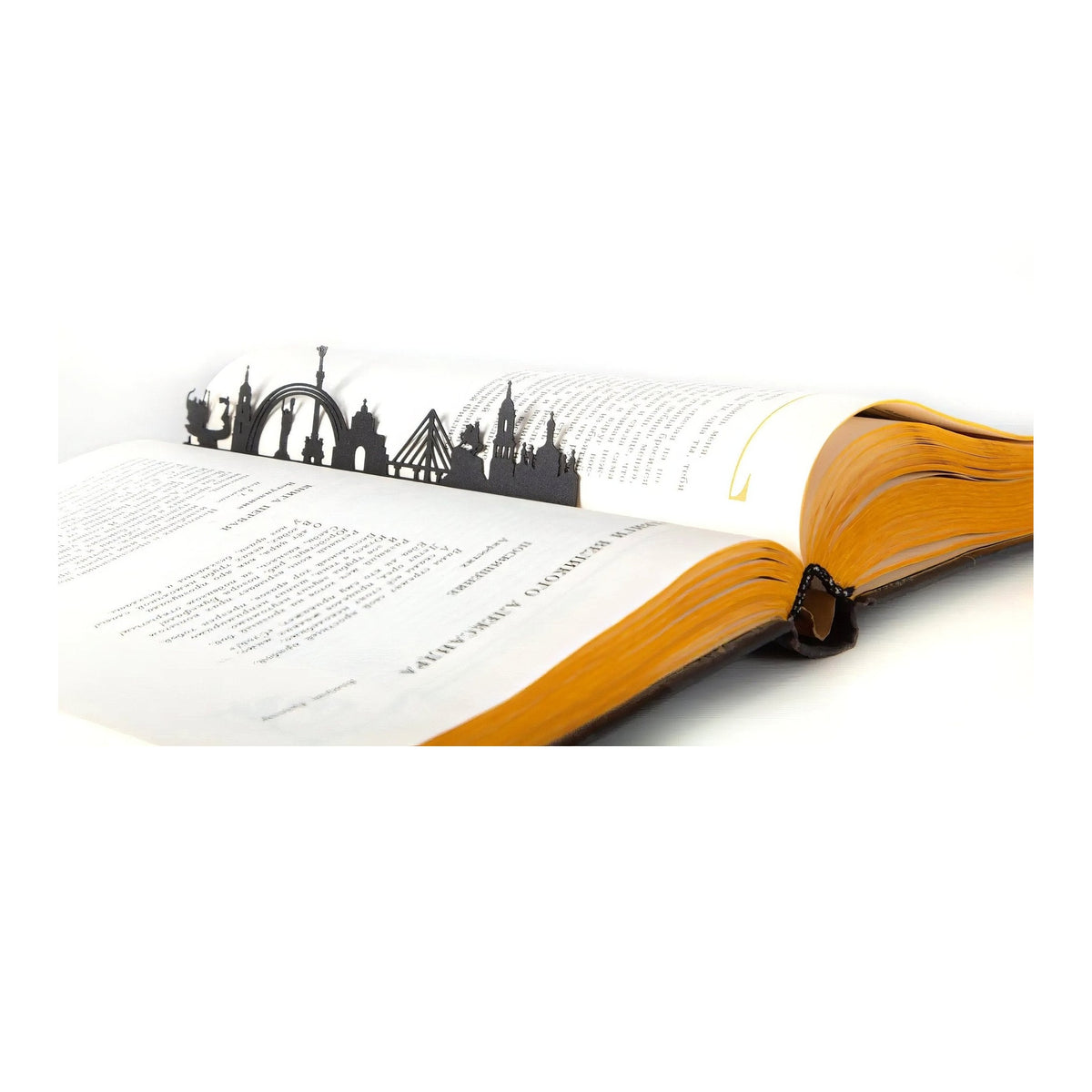 Kyiv Cityscape metal bookmark resting on the pages of an open book