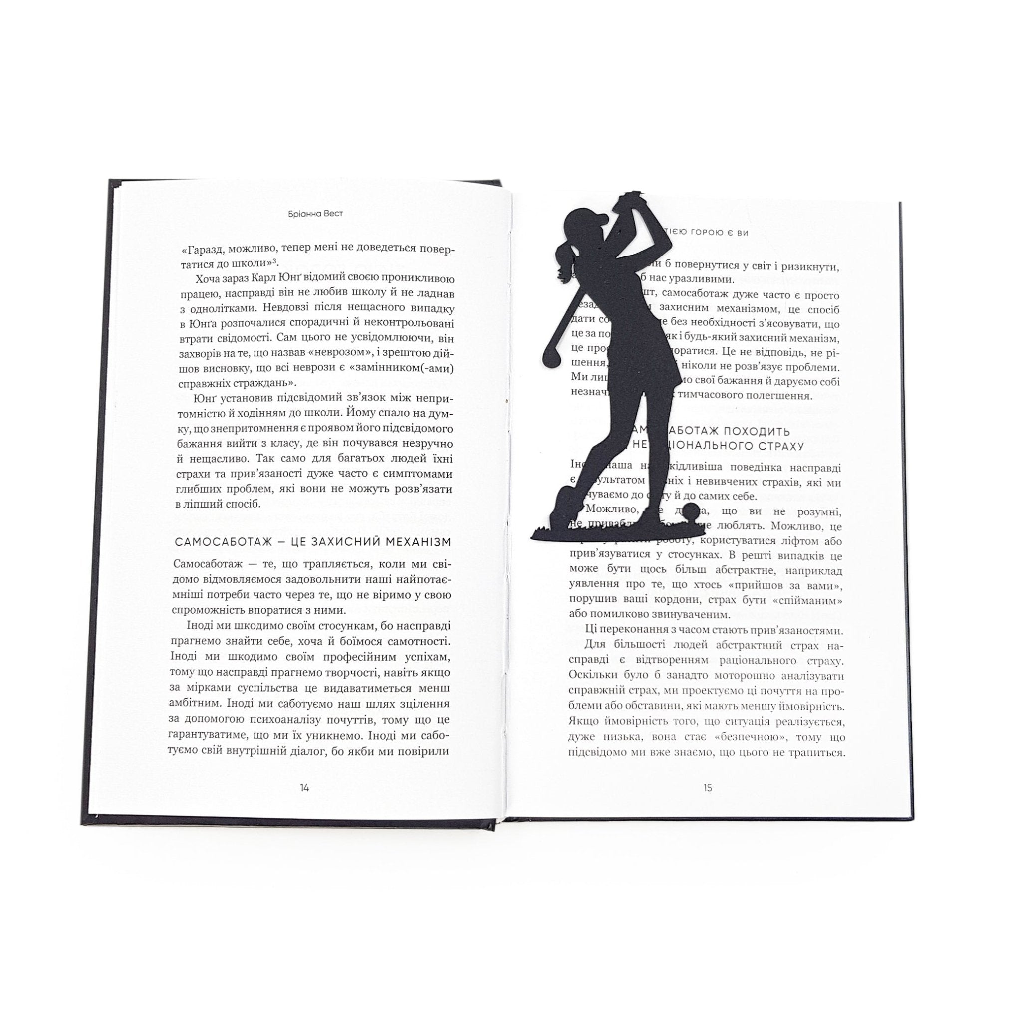 Black metal lady golf player bookmark standing inside an open book, marking the page with a slim silhouette design
