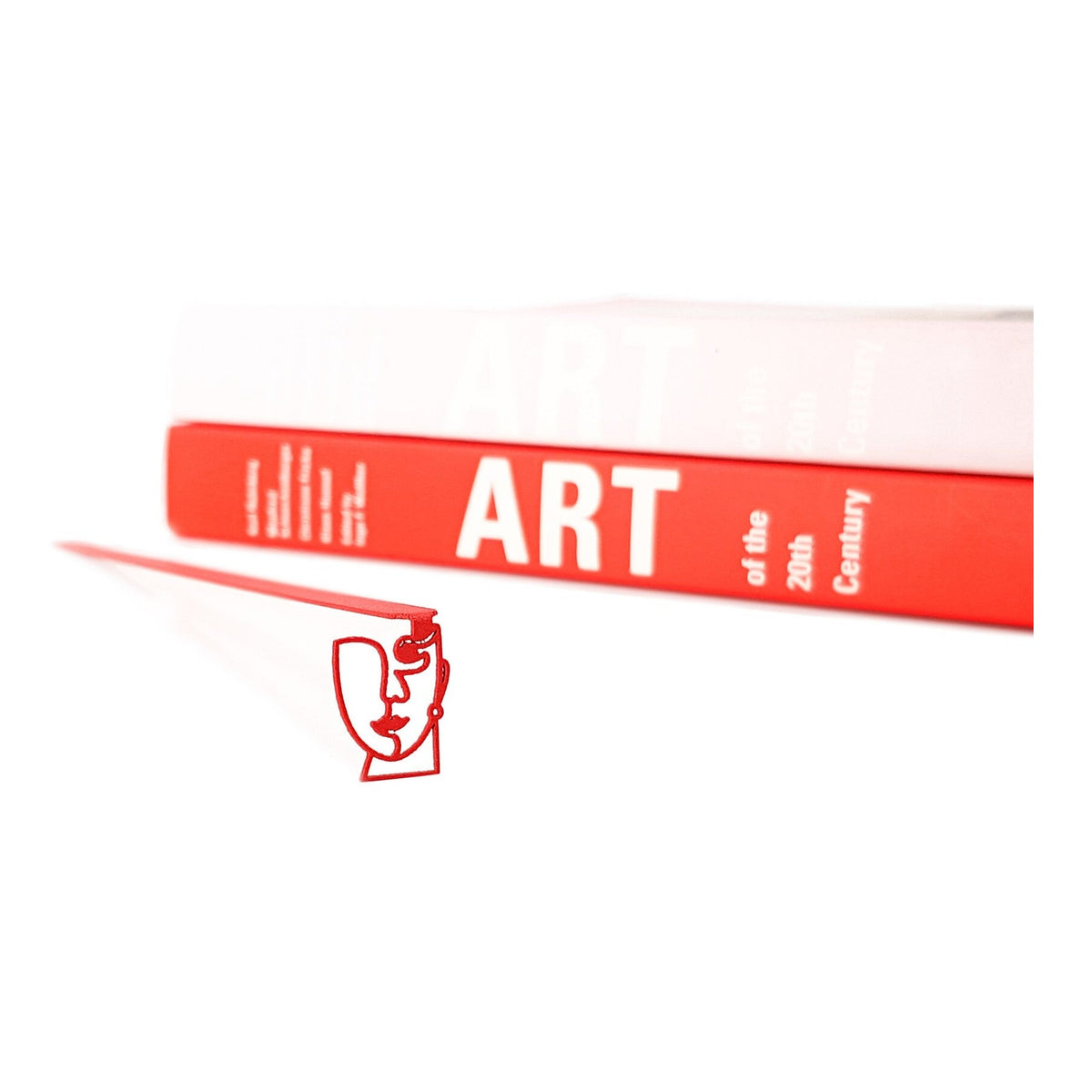 Lady in Red metal bookmark in red in a closed book, only its top showing above the pages
