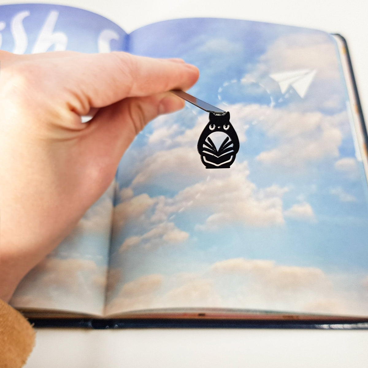 Laser Cut Metal Owl bookmark marking a page in an illustrated book