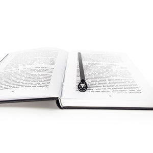 Black owl metal bookmark placed vertically inside an open book, showing the full 6.8-inch slim design and detailed laser cut owl silhouette.