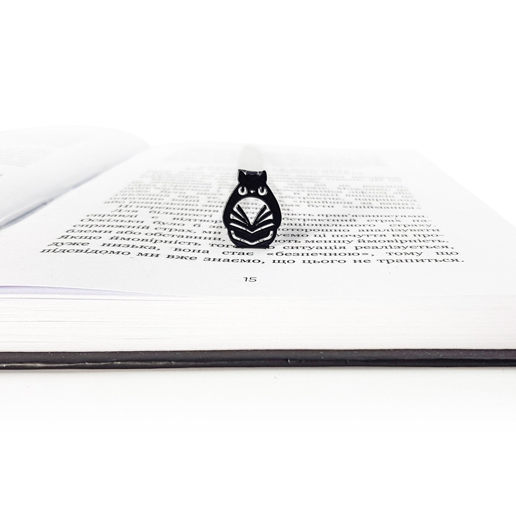 Laser Cut Metal Owl bookmark set into the gutter of an open book