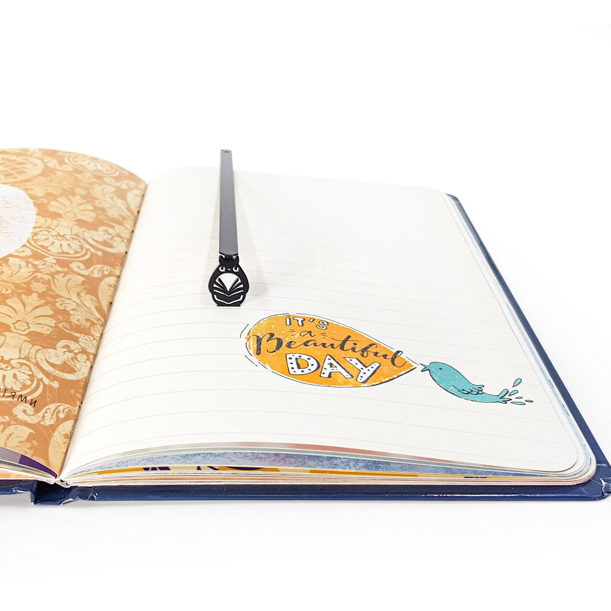 Laser Cut Metal Owl bookmark marking a page in an illustrated book, view 4