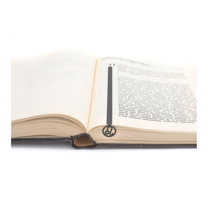 Leo metal bookmark resting on the pages of an open book
