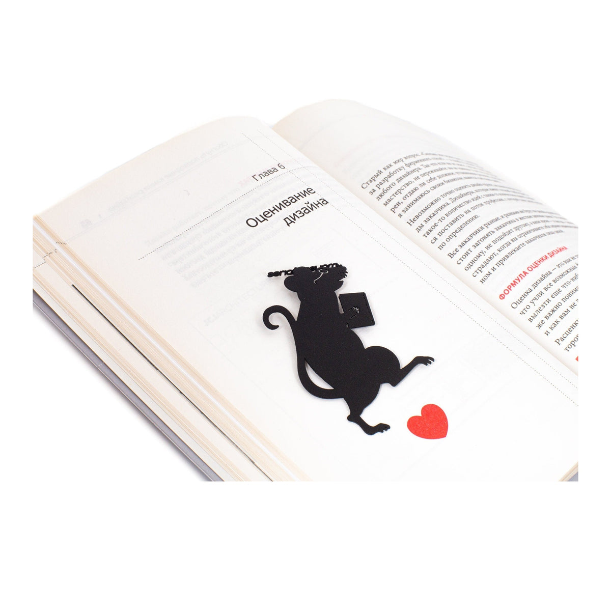 Library Mouse metal bookmark resting on the pages of an open book