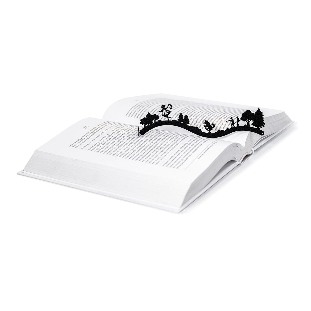 Little Red Riding Hood metal bookmark resting on the pages of an open book