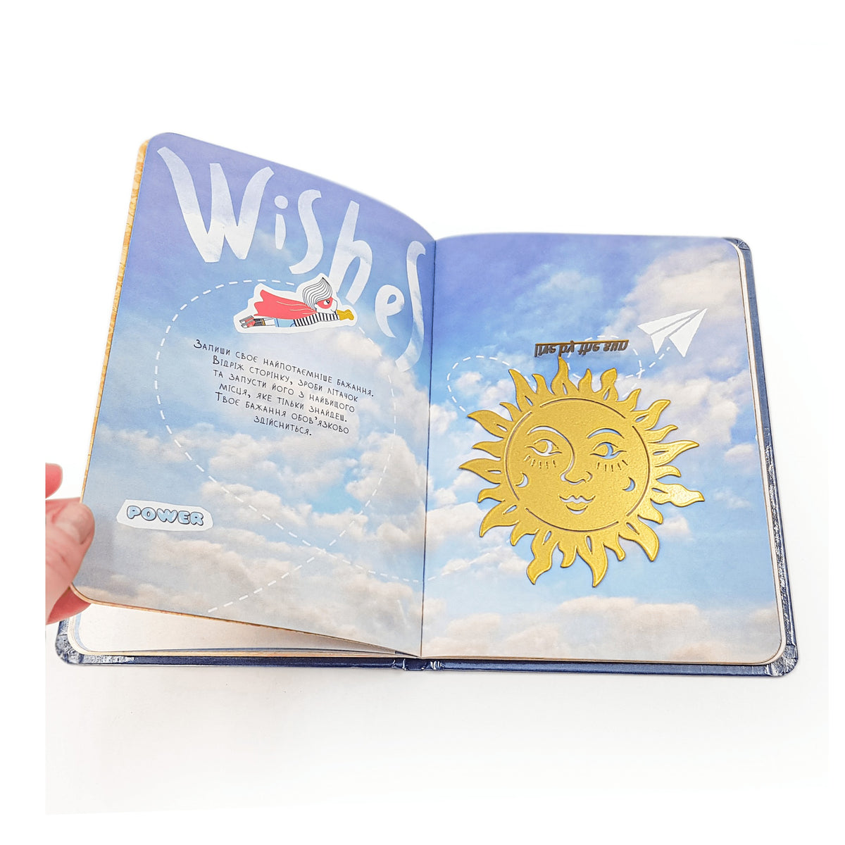 Live by The Sun metal bookmark in gold marking a page in an illustrated book