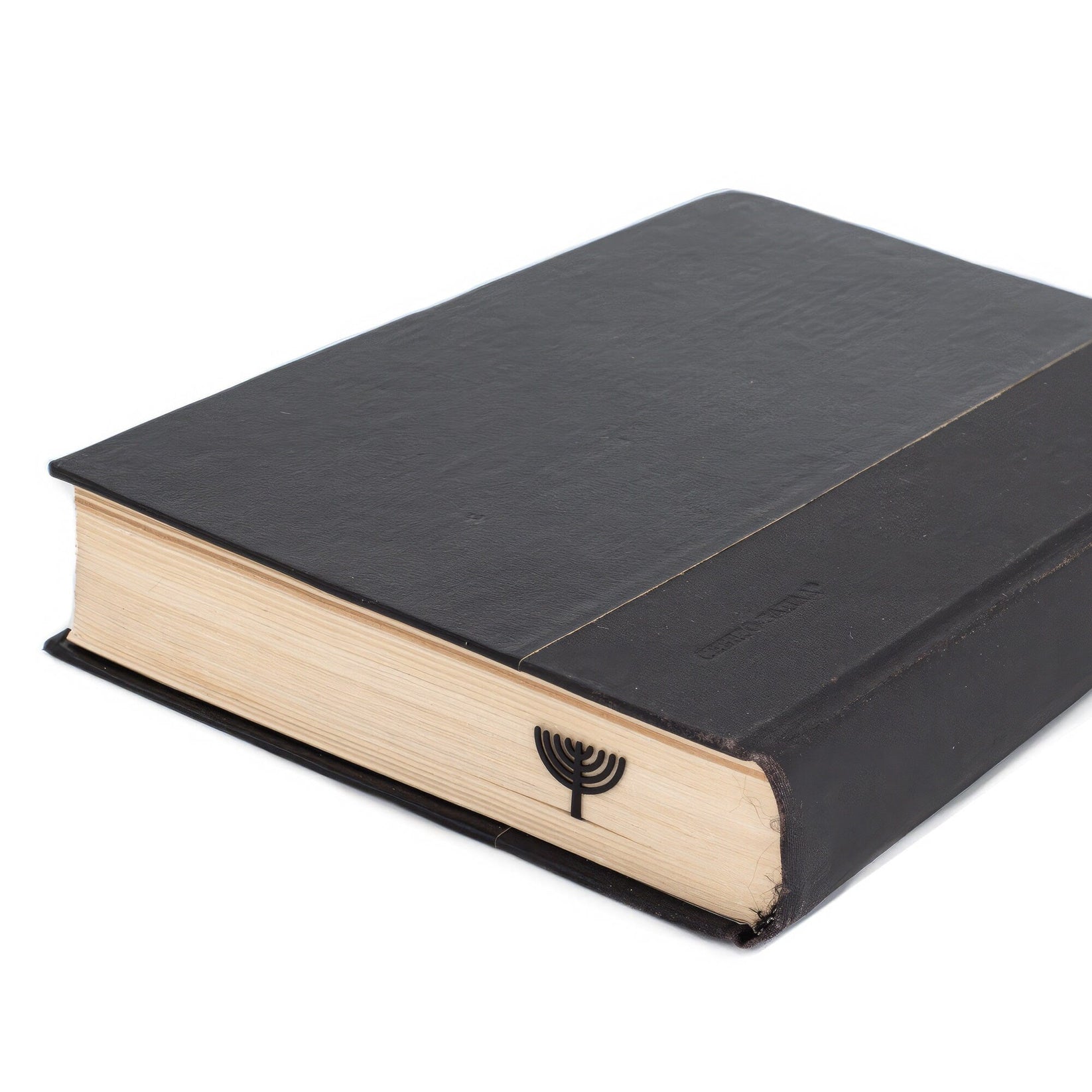 Menorah metal bookmark seen from the edge of a closed book
