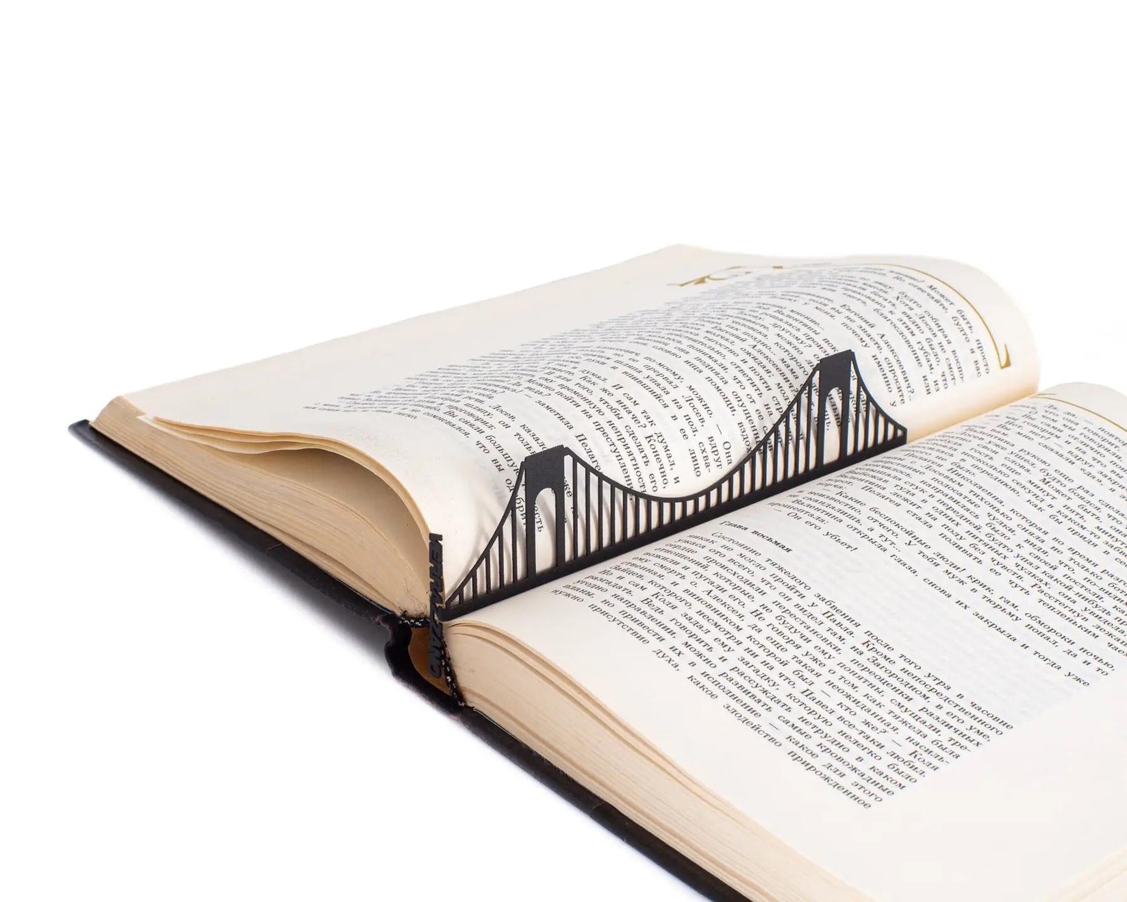 Verrazano Bridge metal bookmark resting on the pages of an open book