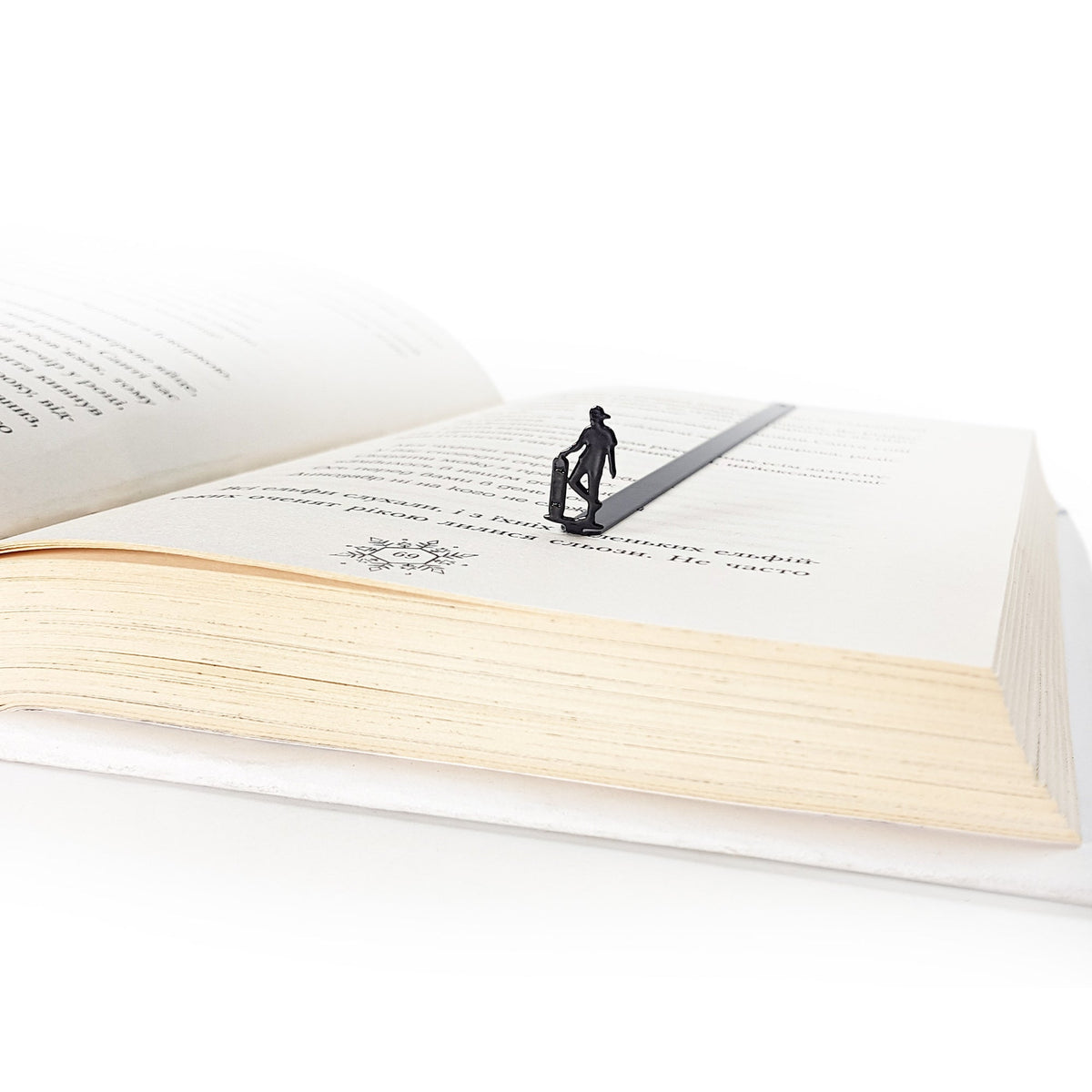 Metal Skater bookmark set into the gutter of an open book