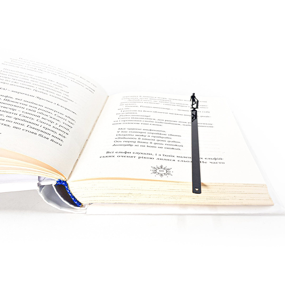 Metal Skater bookmark resting on the pages of an open book
