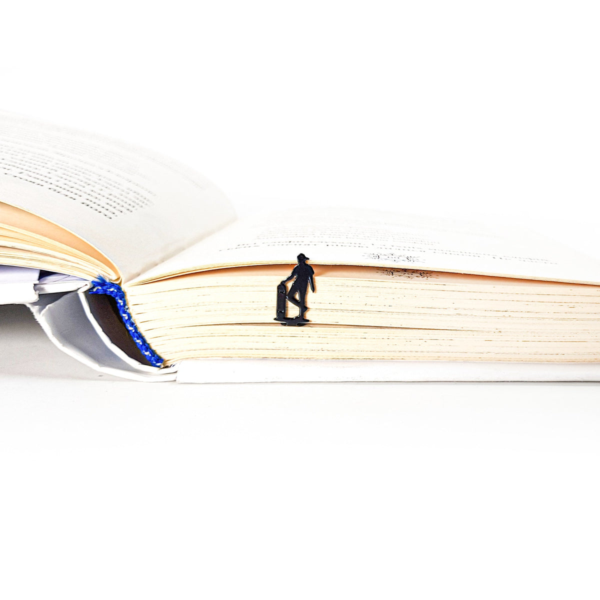 Metal Skater bookmark lying across the pages of an open book