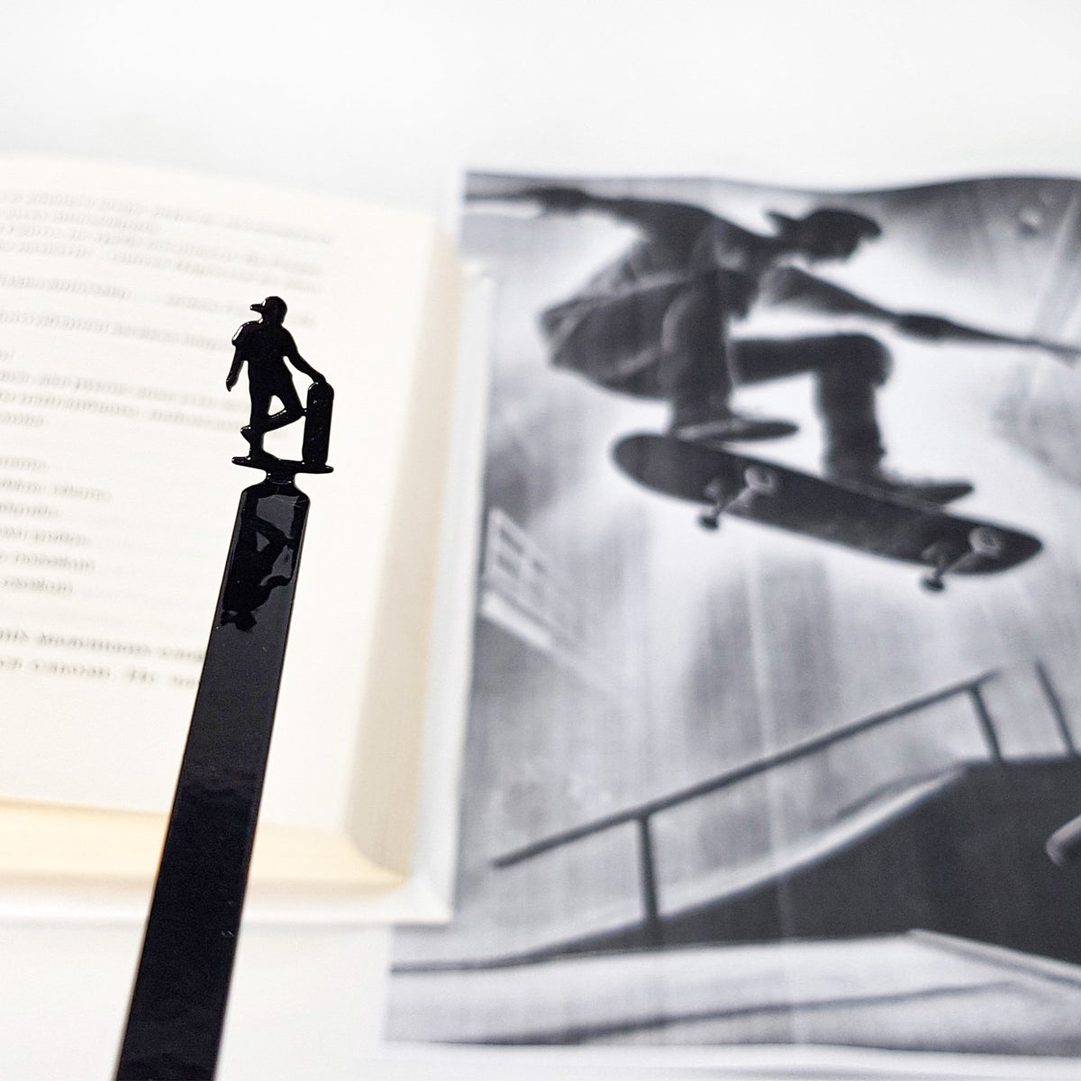 Metal Skater bookmark marking a page in an illustrated book