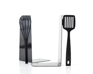 Black spatula and whisk cookbook bookends on a kitchen shelf