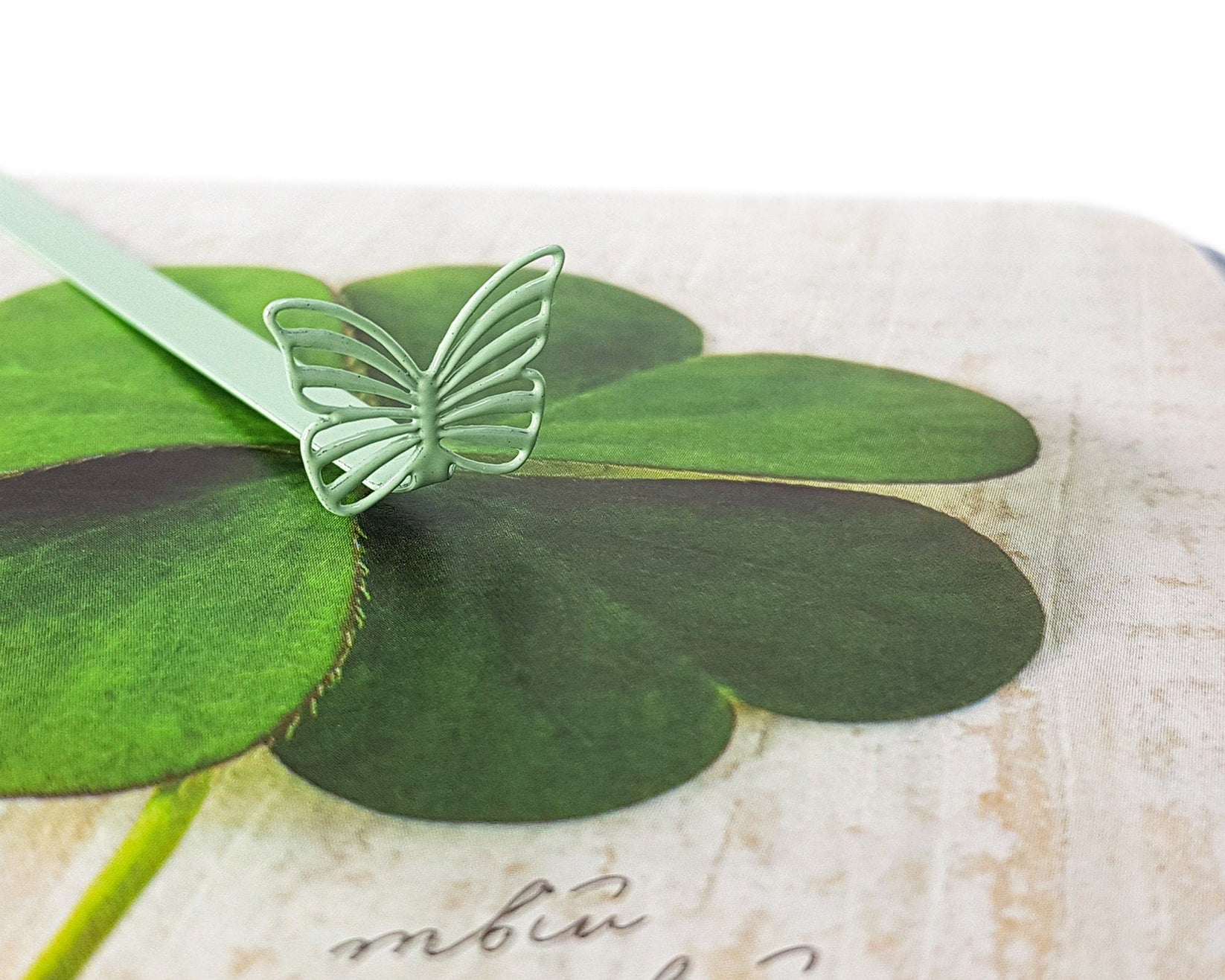 Mint Butterfly metal bookmark in green on a coloured background
