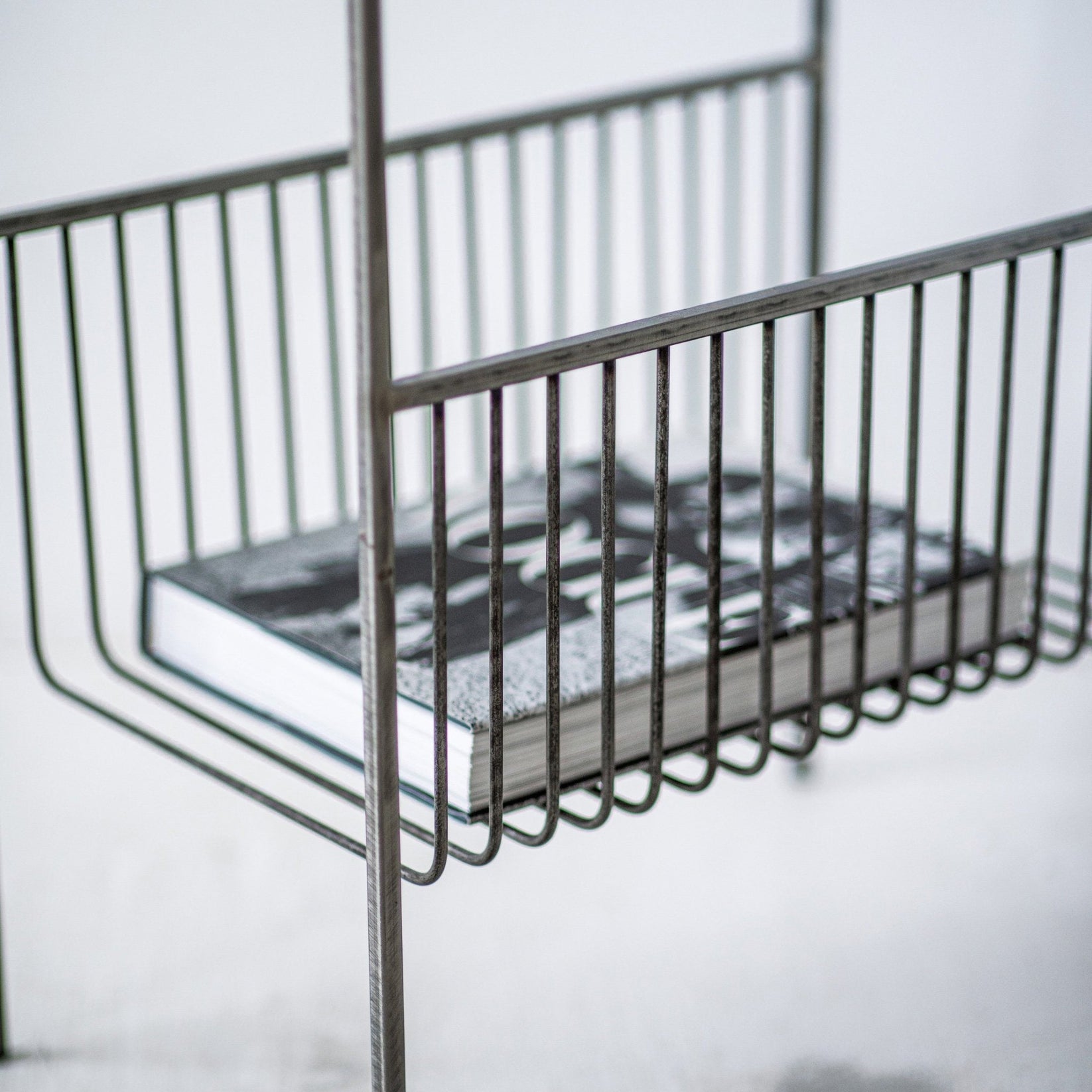 Close-up of the hand-welded steel basket and frame for vinyl record storage