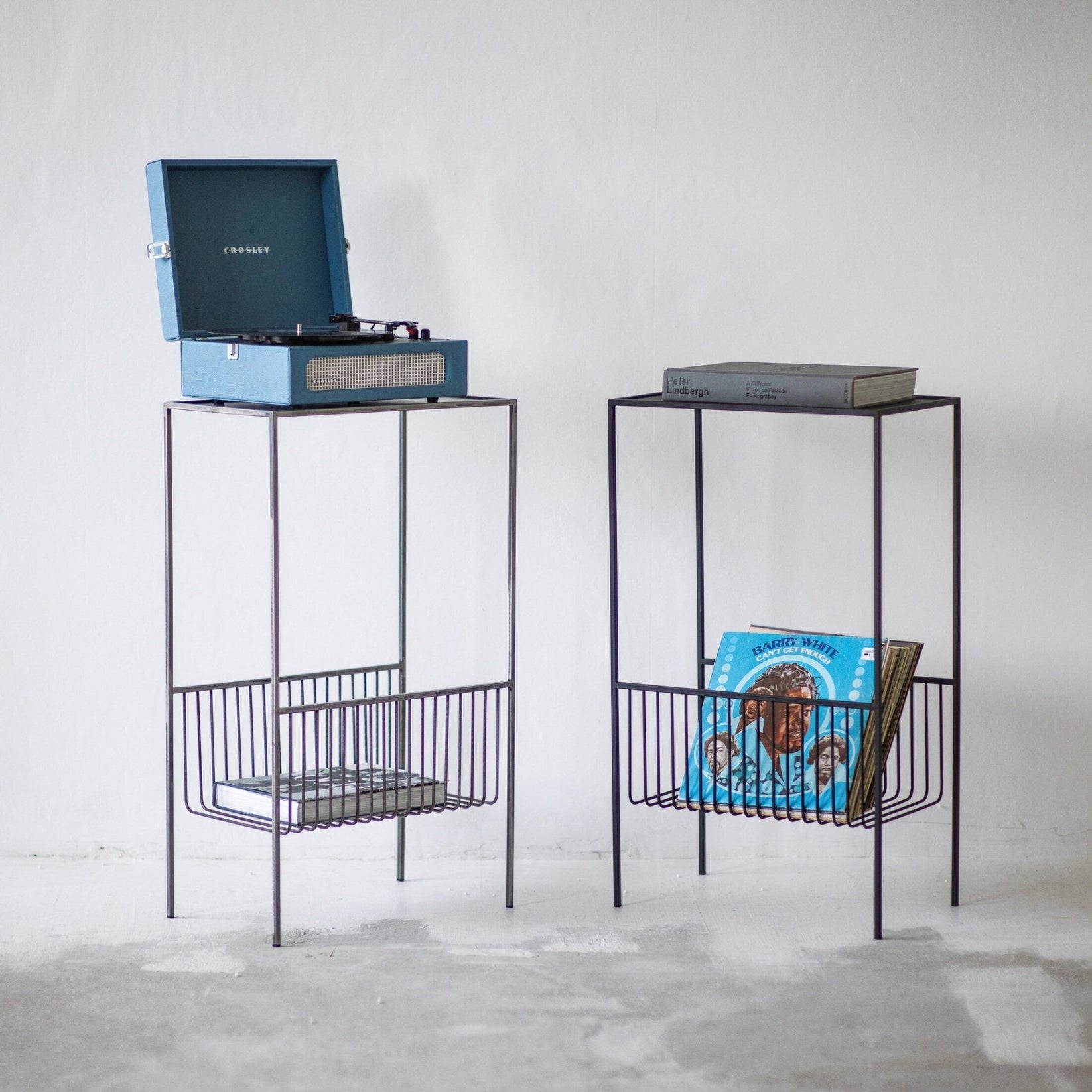 Raw steel and black record player stands shown side by side with LP storage