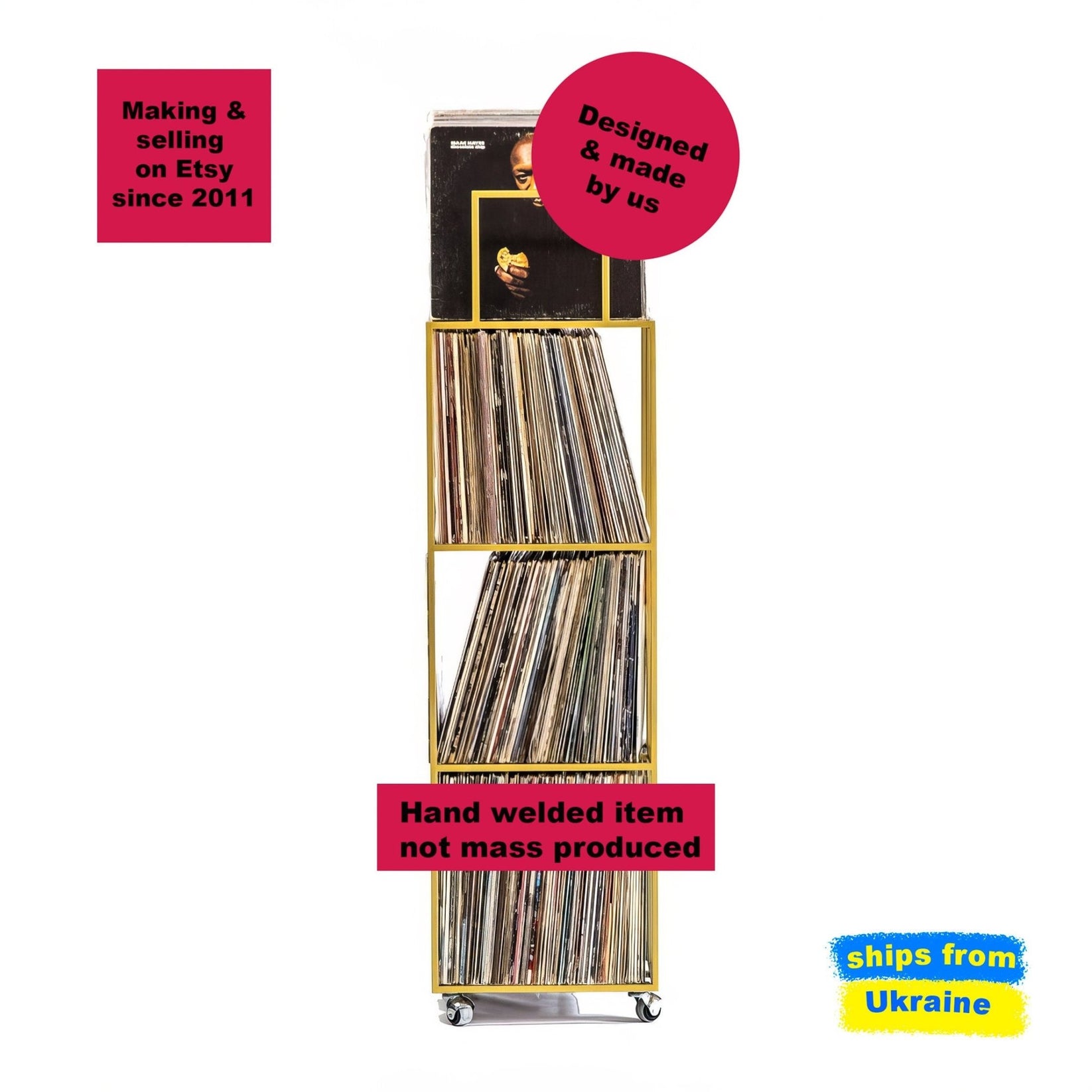 Tall gold metal vinyl record storage rack with four shelves, filled with LPs and standing on caster wheels.