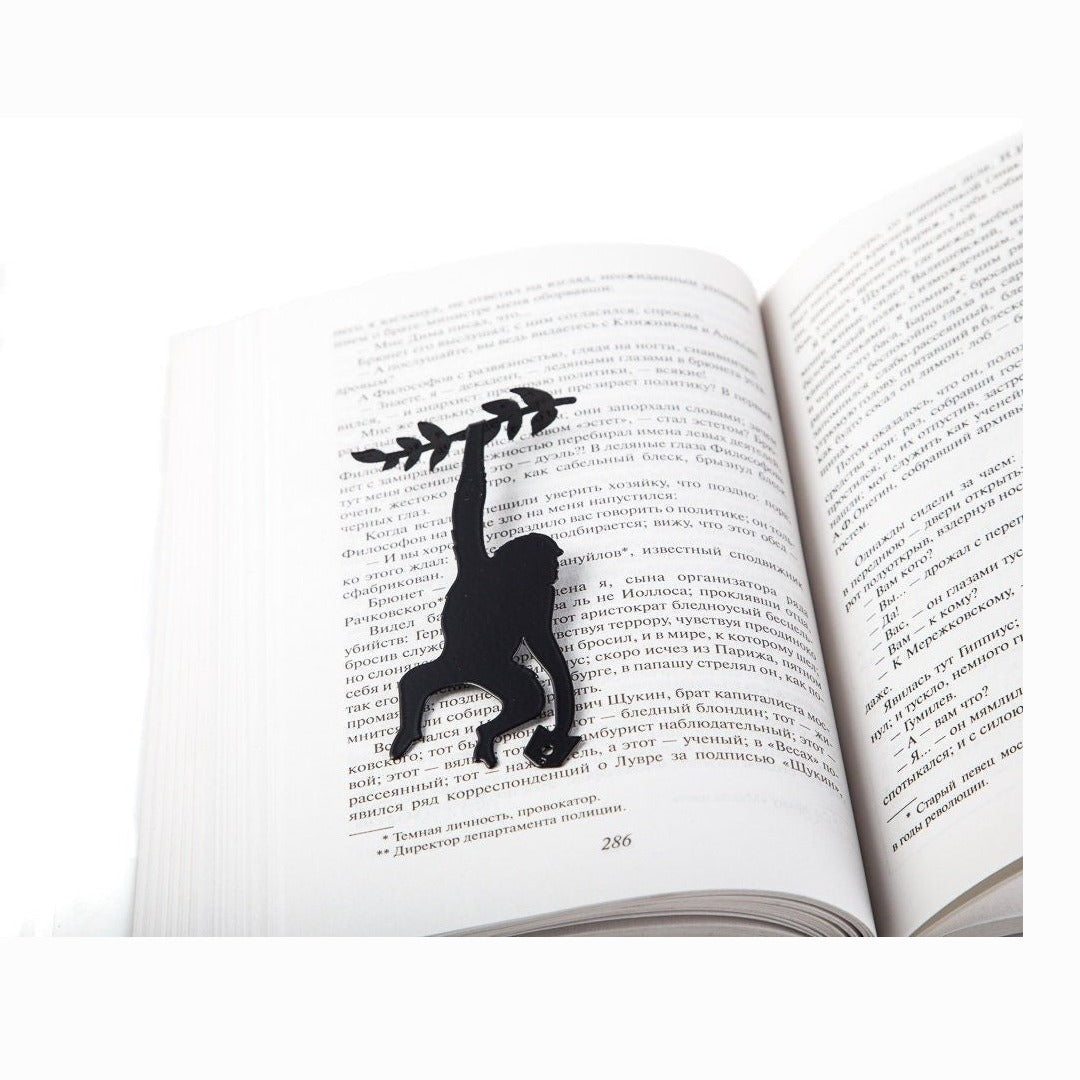 Monkey, Library in the Jungle metal bookmark resting on the pages of an open book
