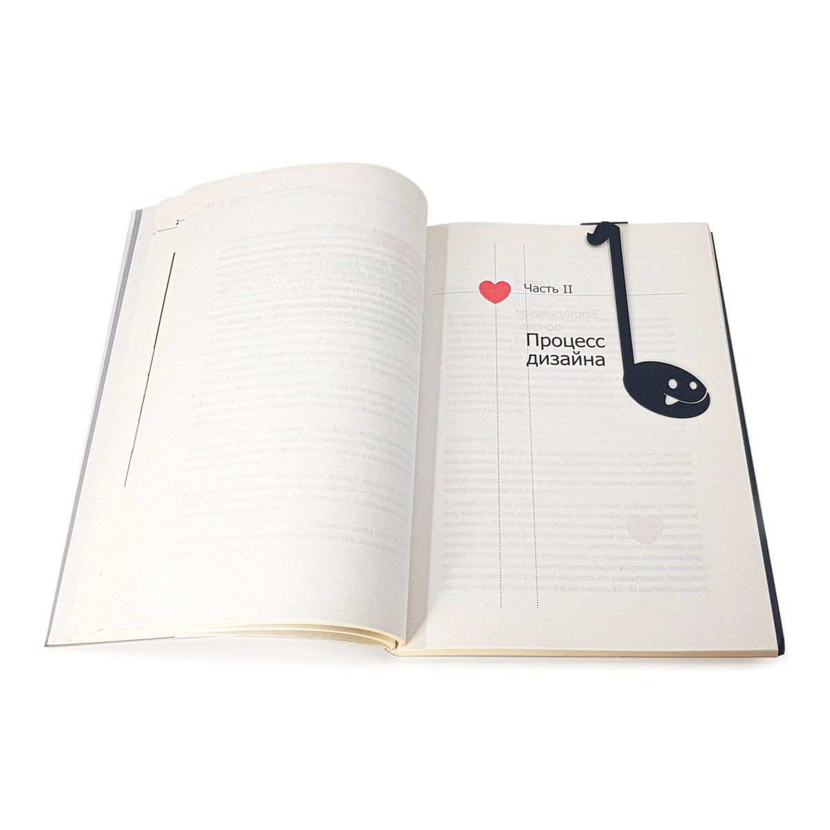 Musical Note metal bookmark resting on the pages of an open book