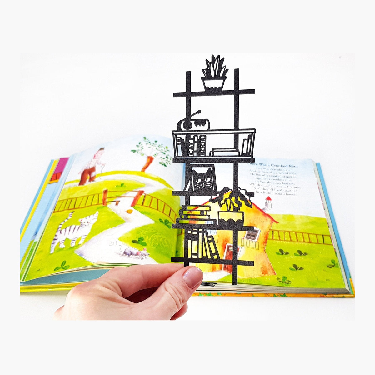 My Bookshelf metal bookmark marking a page in an illustrated book