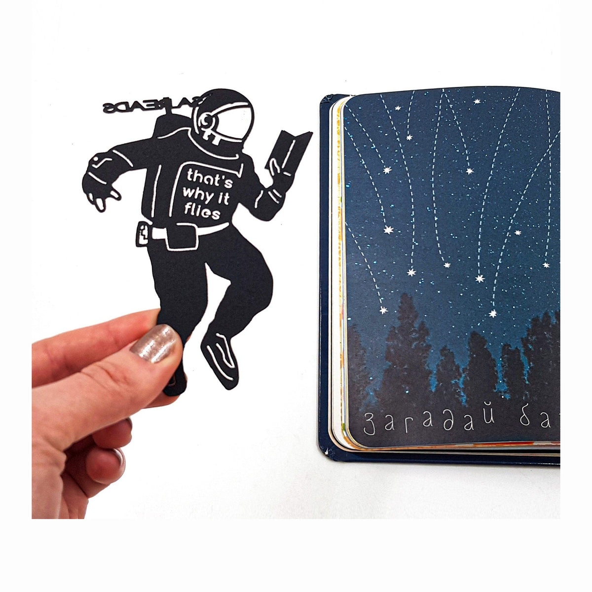 NASA Astronaut metal bookmark on a coloured background