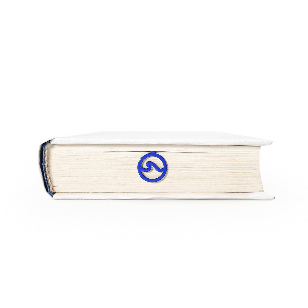Nautical Big Wave metal bookmark in blue seen from the edge of a closed book