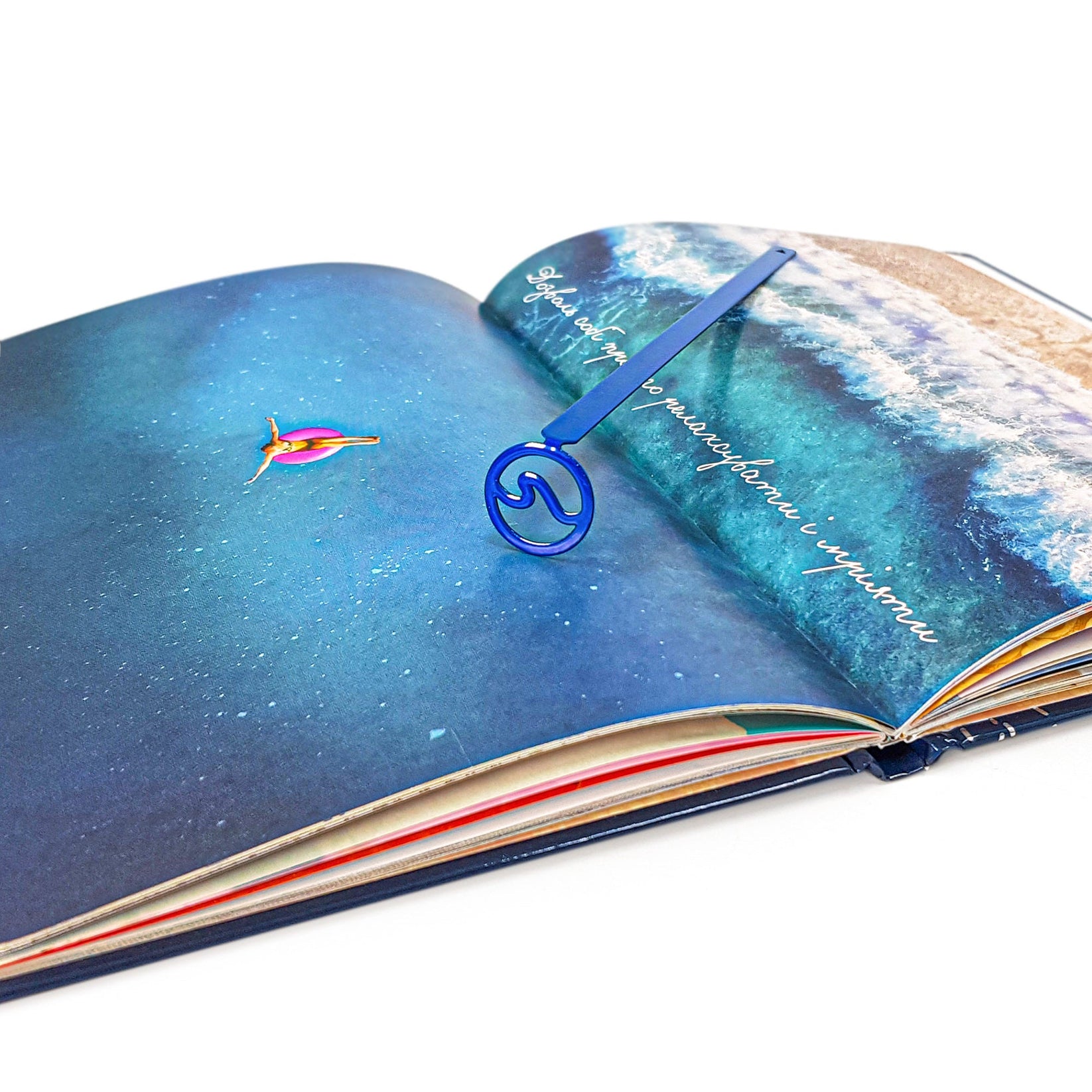Nautical Big Wave metal bookmark in blue on an illustrated page