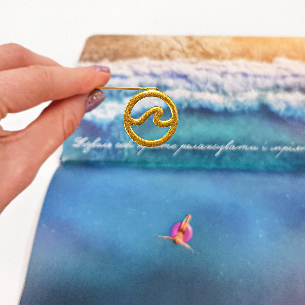 Nautical Big Wave metal bookmark in blue placed on a colour illustration