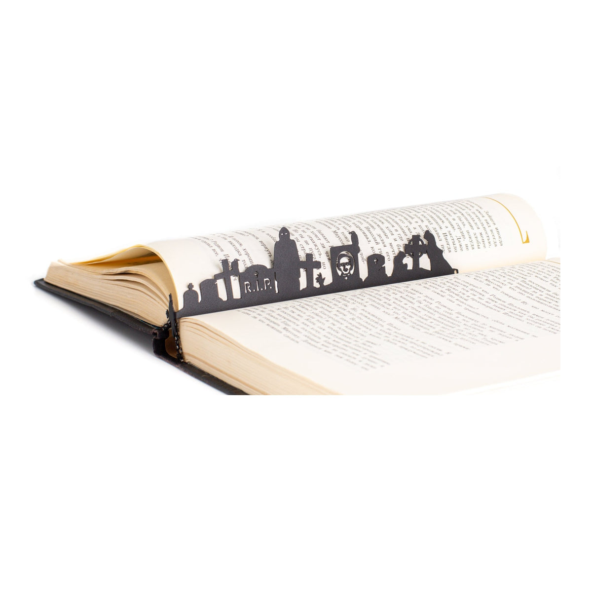 Night at the Cemetery metal bookmark resting on the pages of an open book