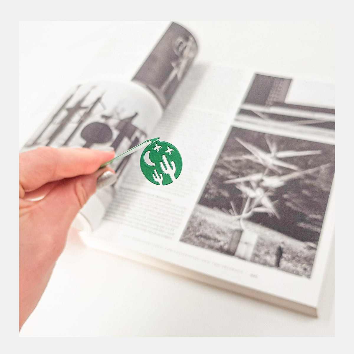 Night in the Desert metal bookmark marking a page in an illustrated book