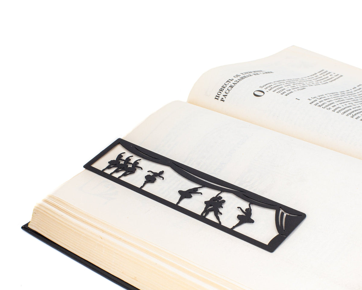 Ballet metal bookmark resting on the pages of an open book