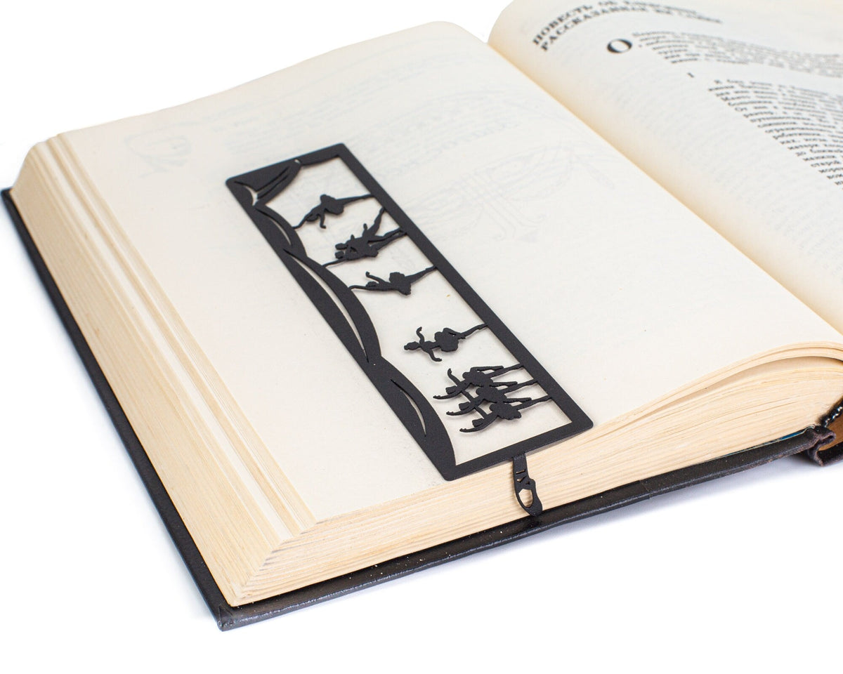 Ballet metal bookmark marking a page in an open book