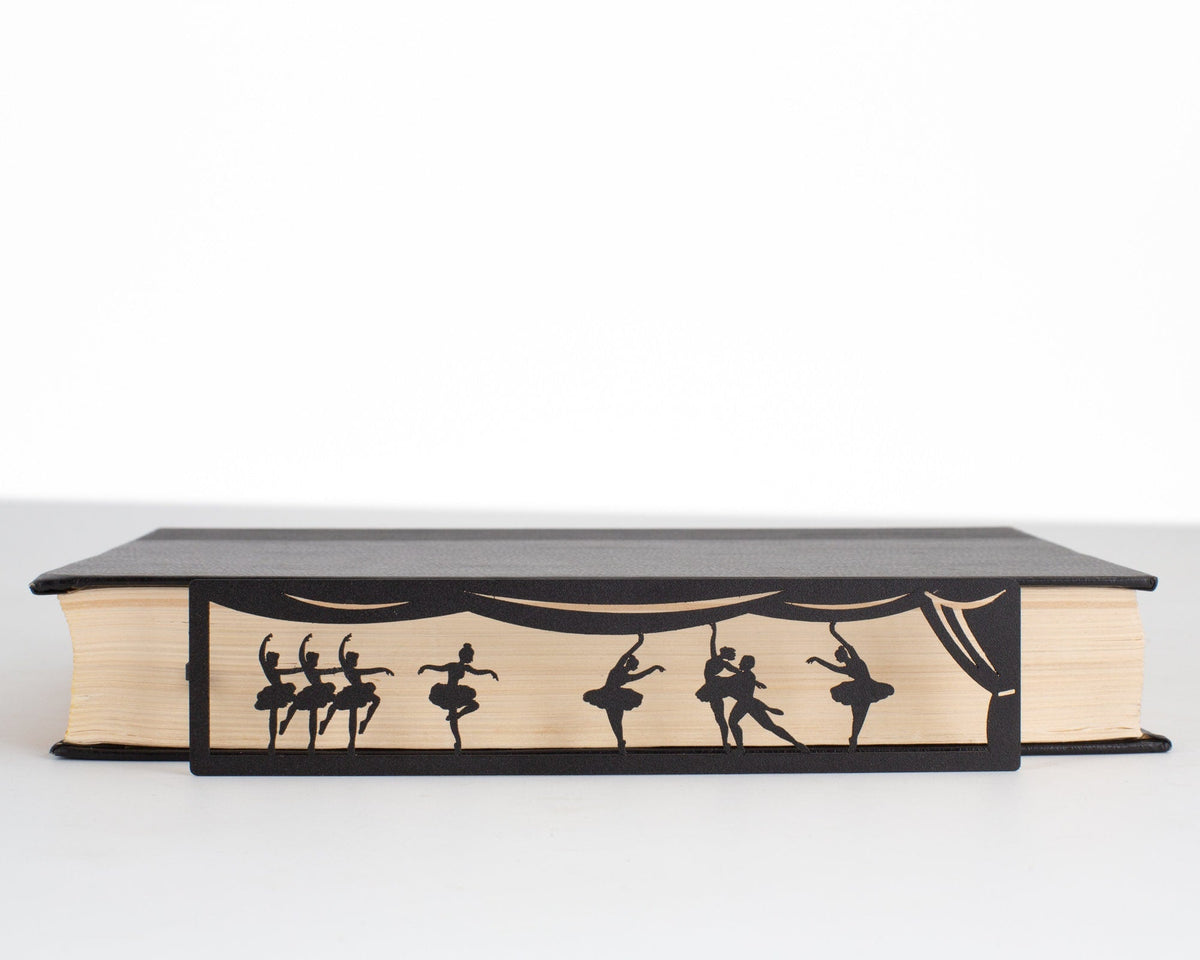 Ballet metal bookmark in a closed book, only its top showing above the pages