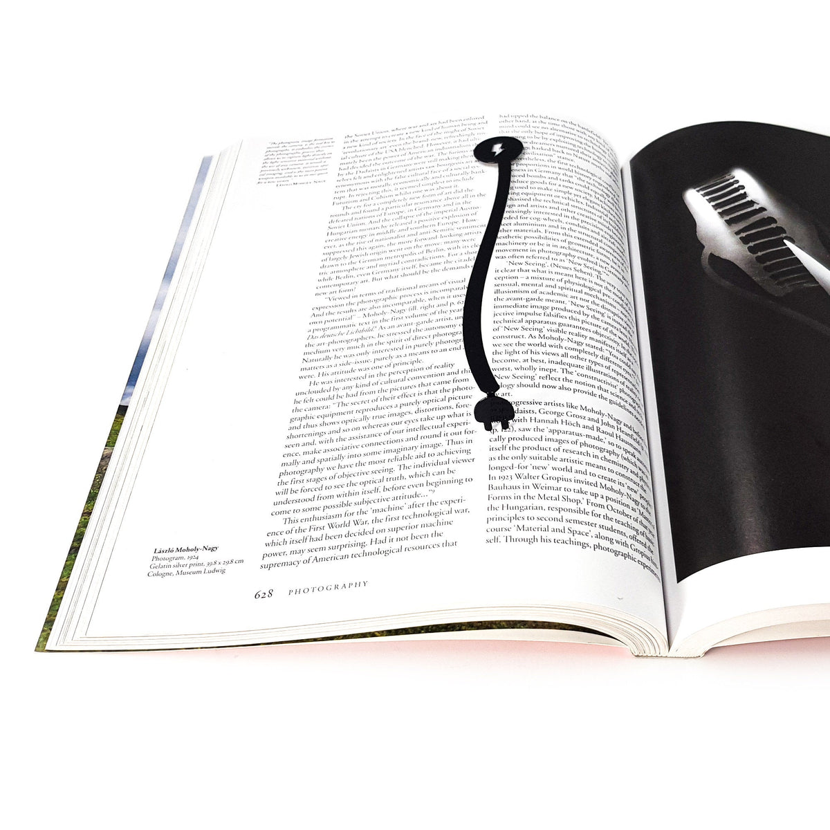 Electrical Plug metal bookmark on an illustrated page