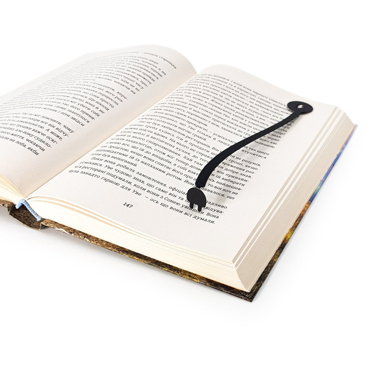 Electrical Plug metal bookmark set into the gutter of an open book