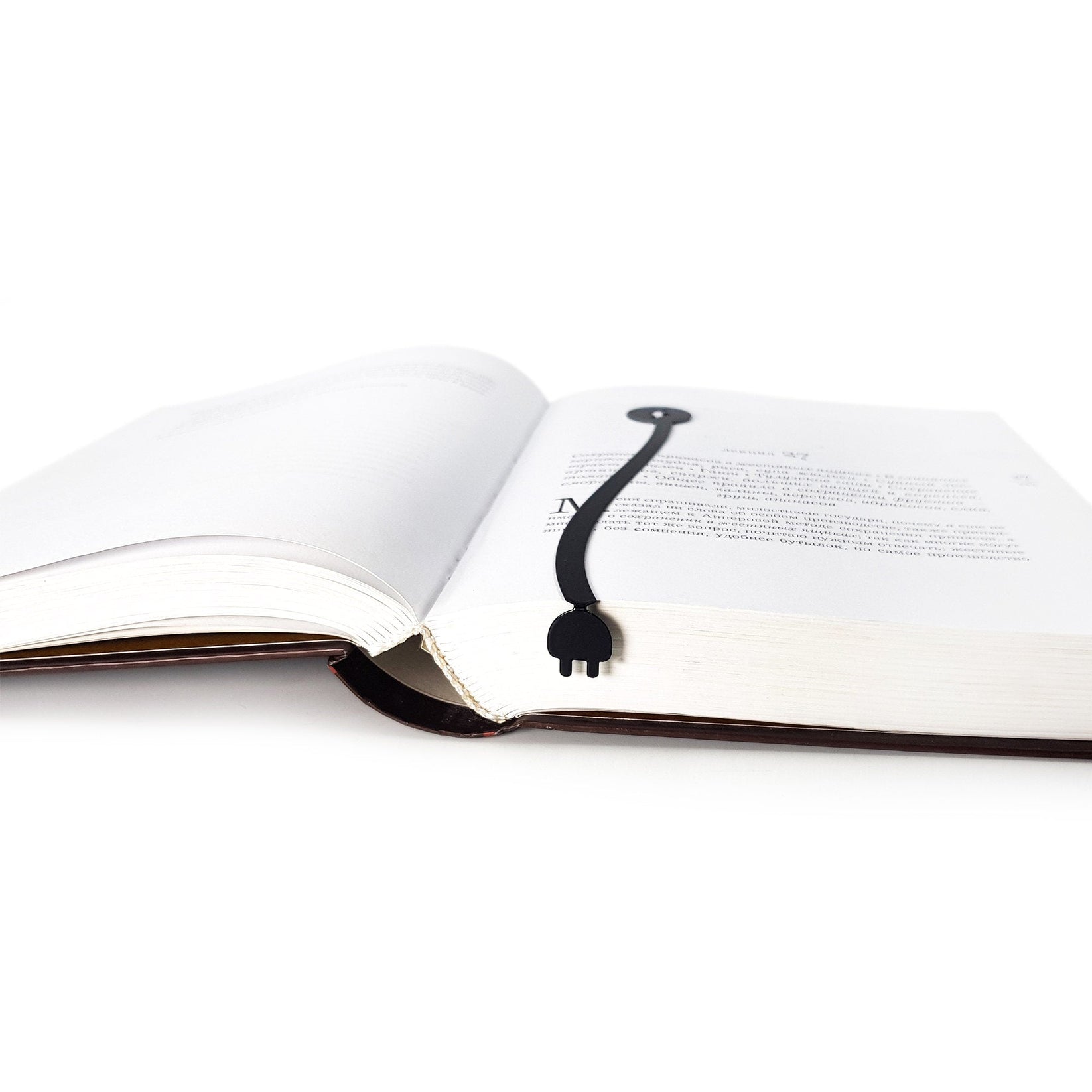 Electrical Plug metal bookmark marking a page in an open book