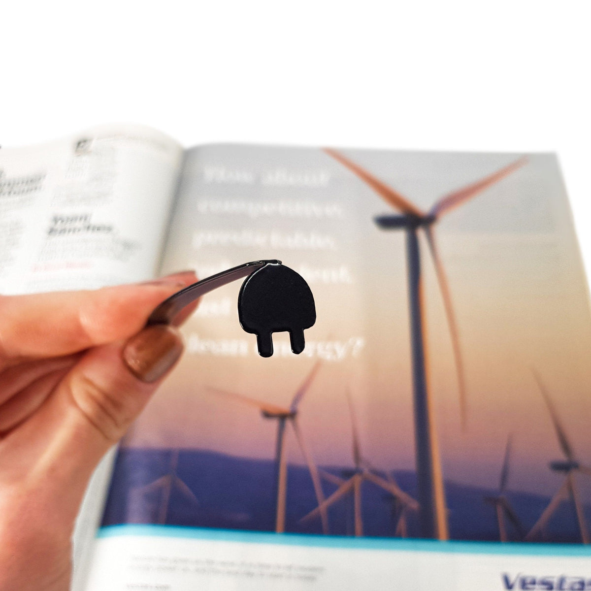 Electrical Plug metal bookmark marking a page in an illustrated book