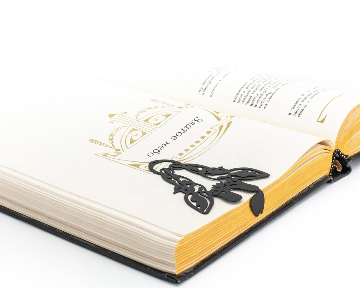 Giraffe Head metal bookmark resting on the pages of an open book