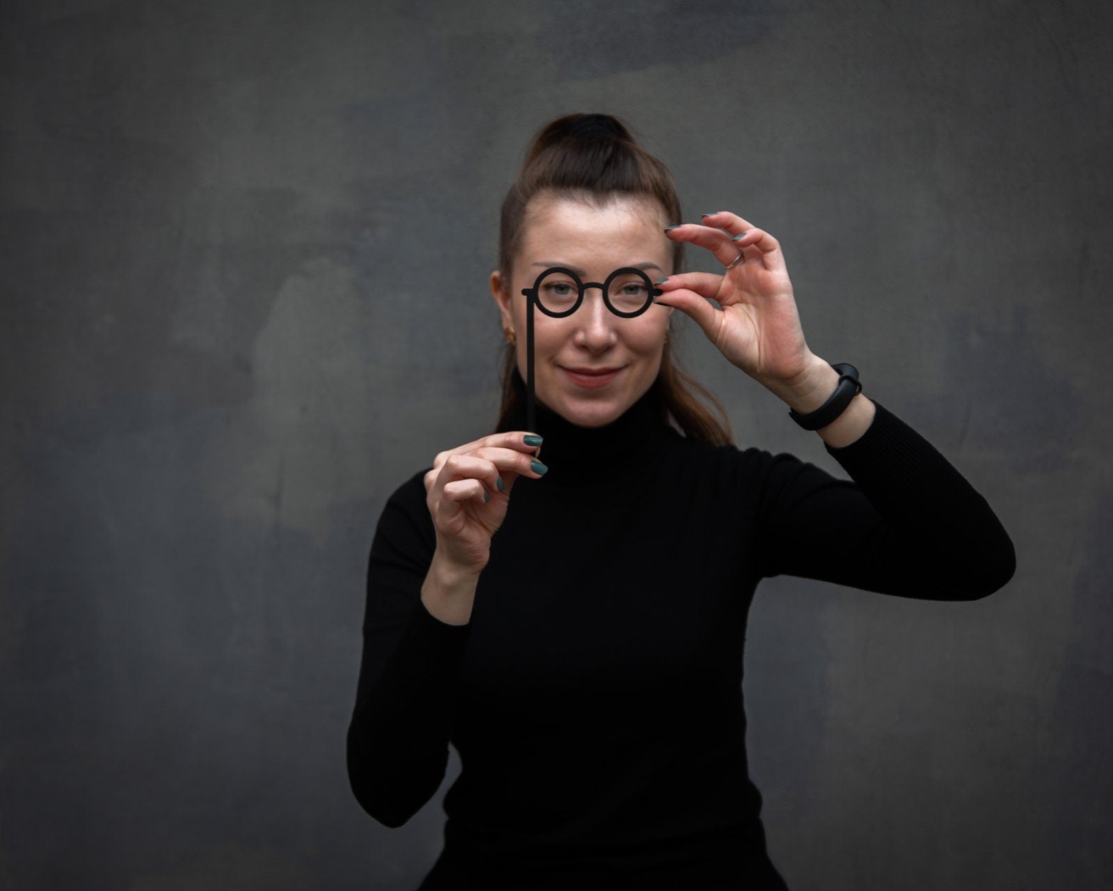 Lorgnettes metal bookmark — woman holds glasses bookmark to her face