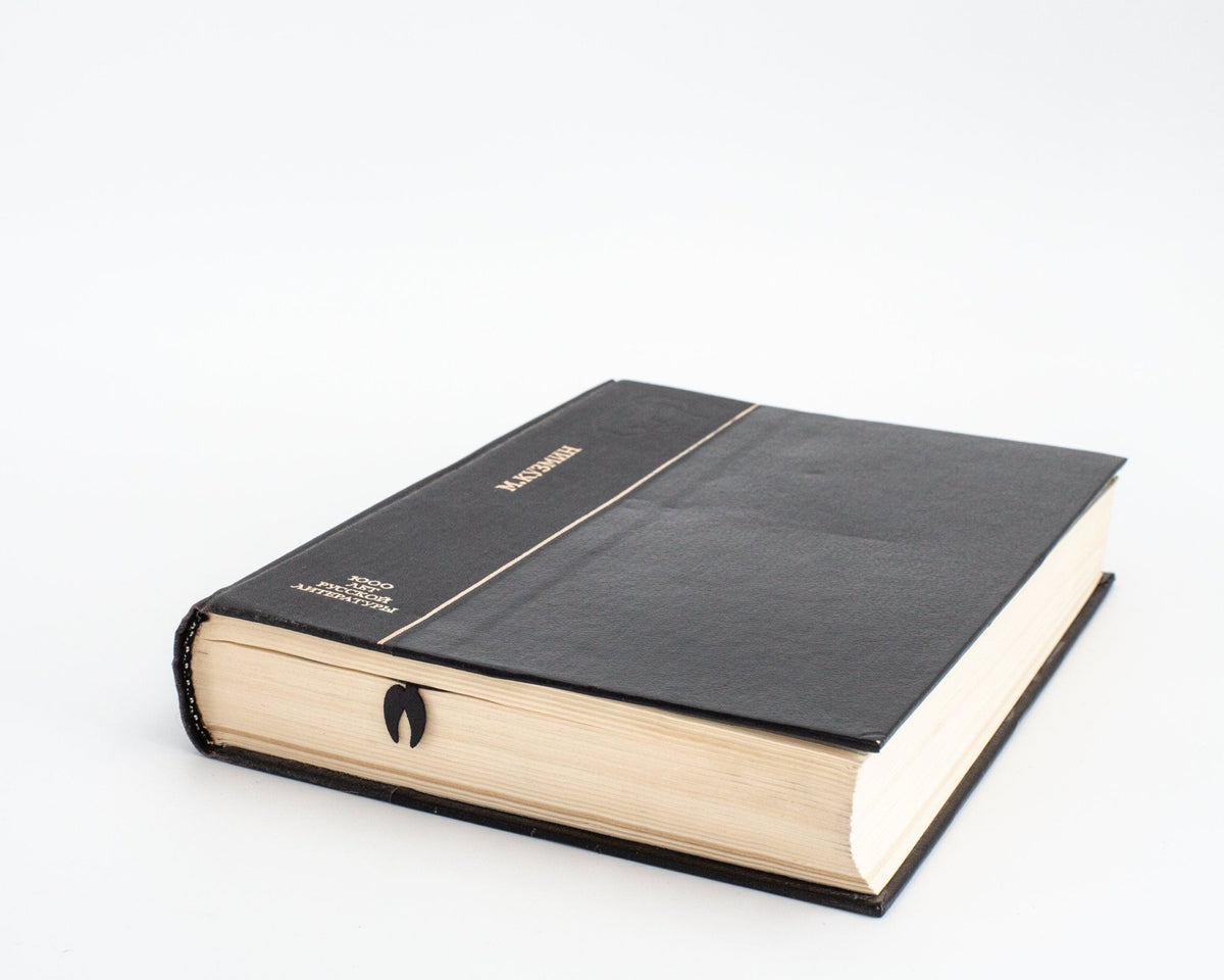 Ram's Head metal bookmark in a closed book, only its top showing above the pages