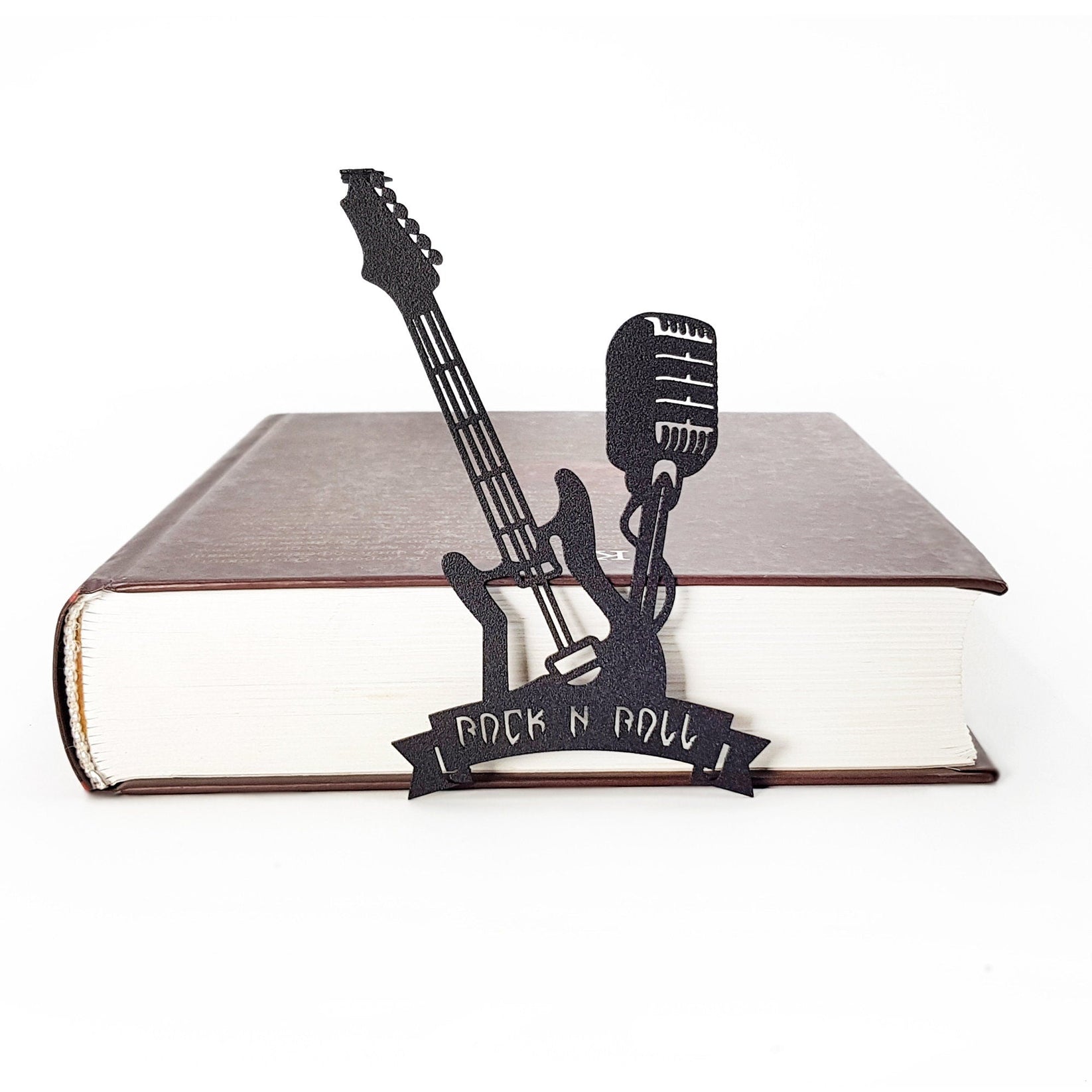 Rock and Roll metal bookmark in a closed book, only its top showing above the pages