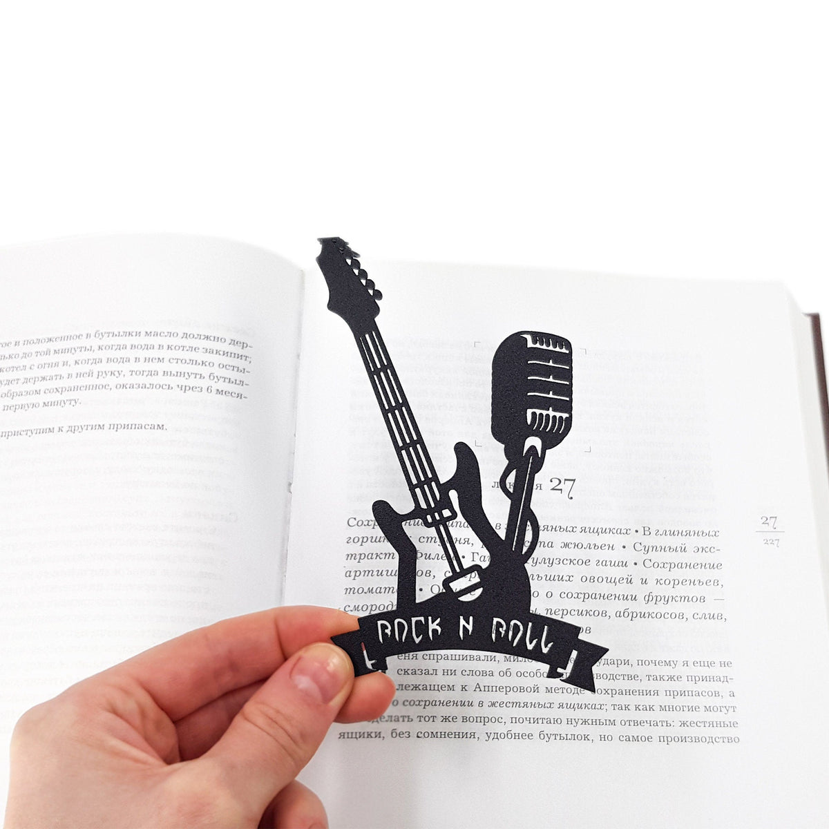 Rock and Roll metal bookmark held in a hand to show its size