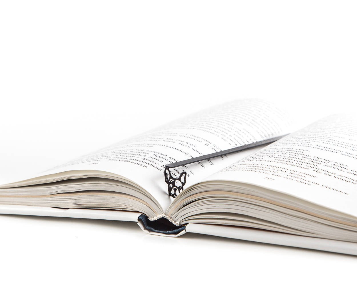 French Bulldog metal bookmark marking a page in an open book