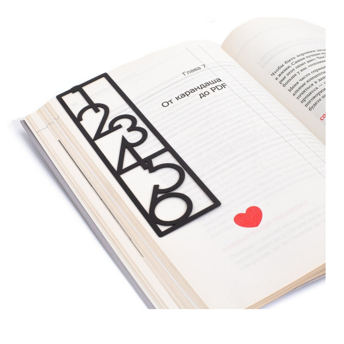 Numbers Bauhaus Style metal bookmark resting on the pages of an open book