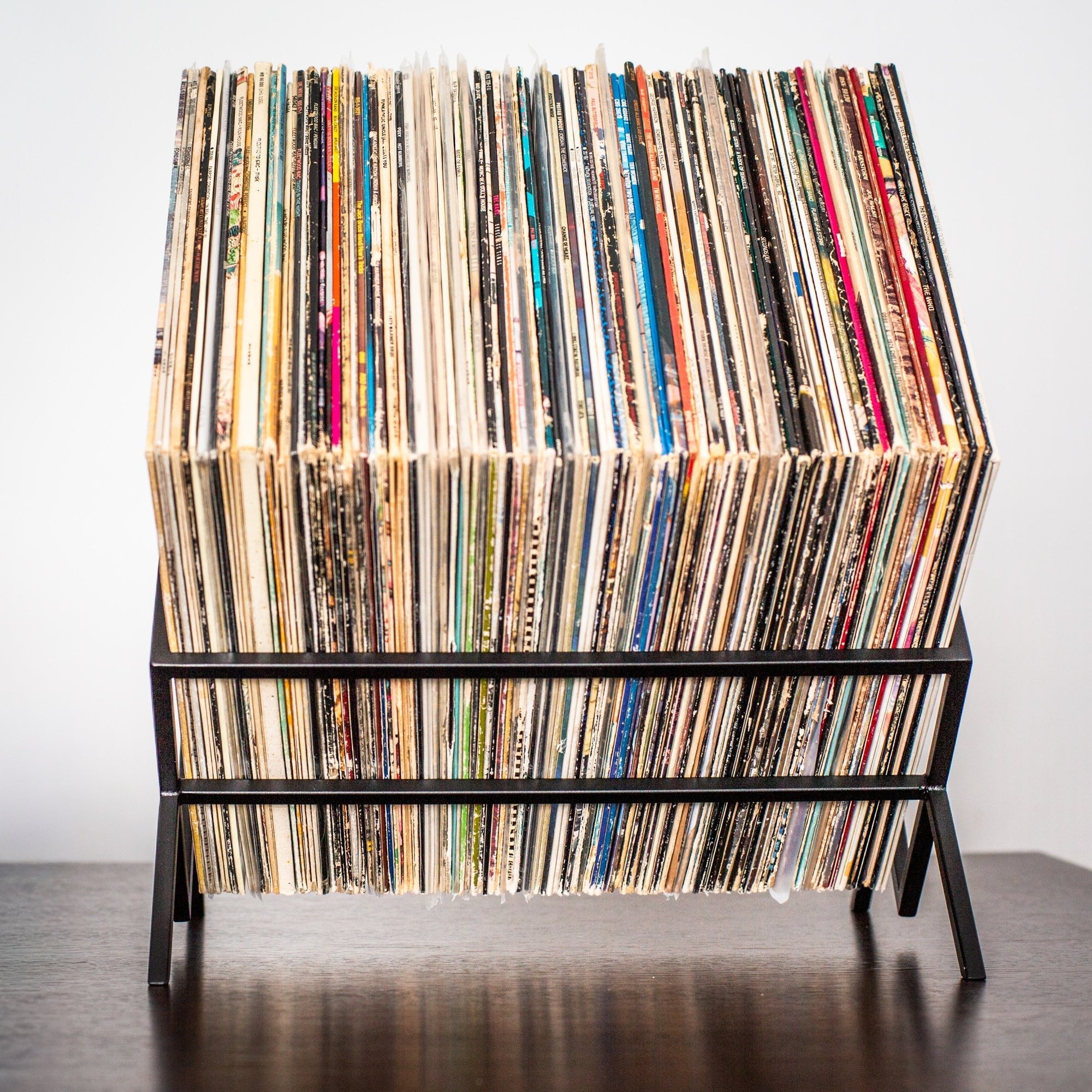 Black 1Romb vinyl record stand holding a single row of records